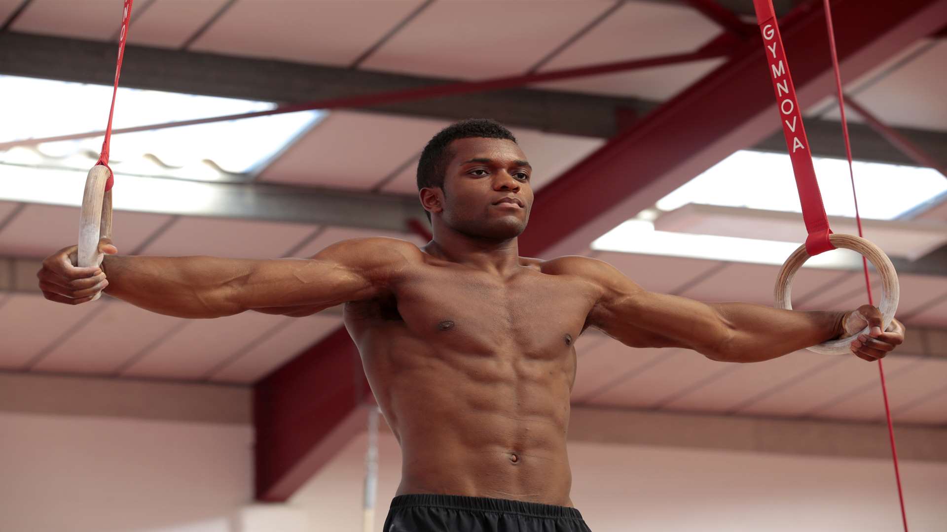 Courtney Tulloch shows his strength on rings Picture: Martin Apps