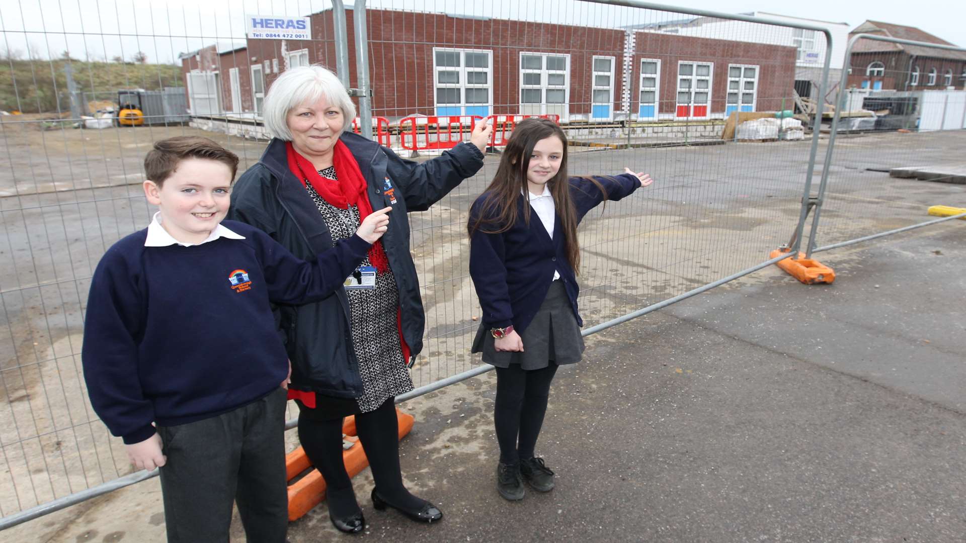 Harvey, 10, head teacher Barbara Convoy, and Emily, 11, outside Queenborough Primary School