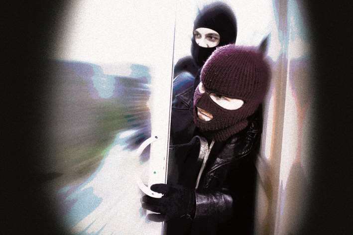 Burglars entering a home. Stock image