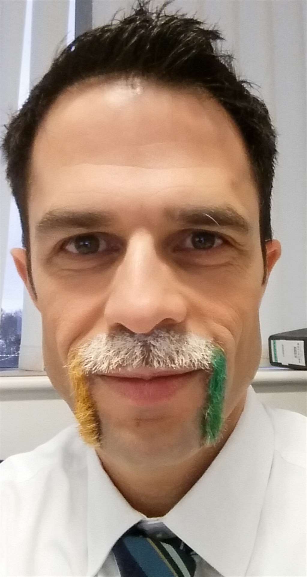 DHA Transport director Jason Lewis dyed his moustache in the gold, white and green corporate colours of construction firm Gallagher Group for Movember