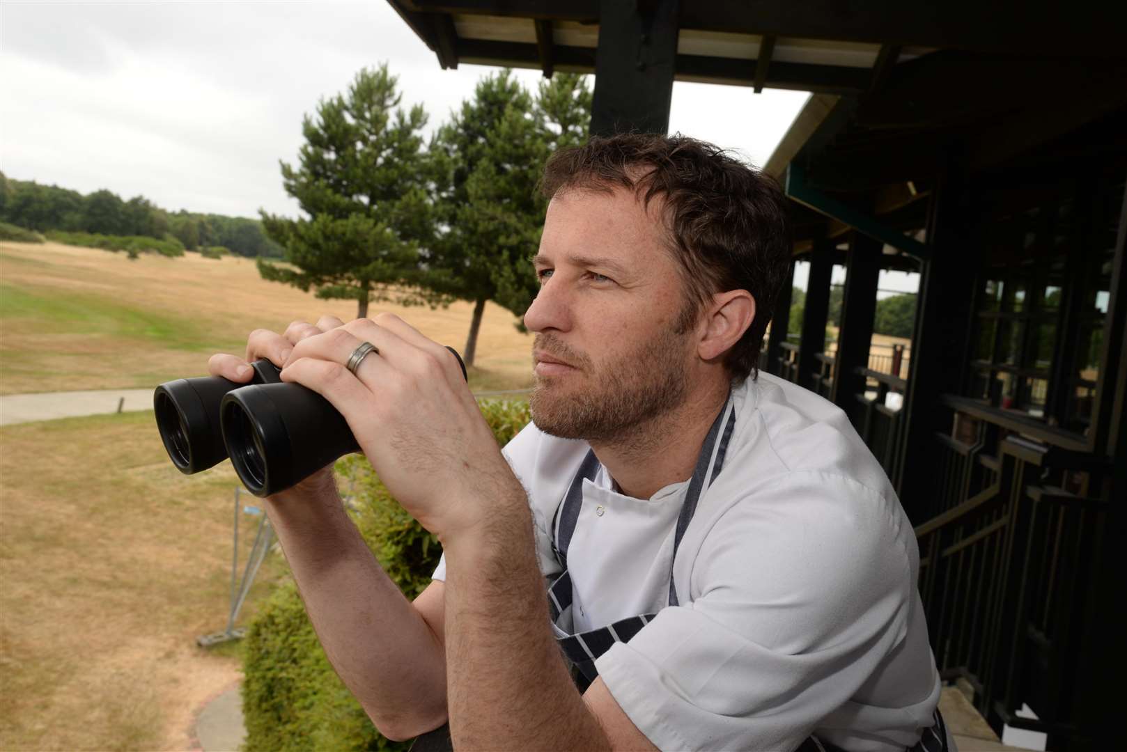 Mike Matthews, executive chef at Kings Hill Golf Club keeps a watch over the course where teenagers have set fire to area's of grass. Picture: Chris Davey. (3002125)