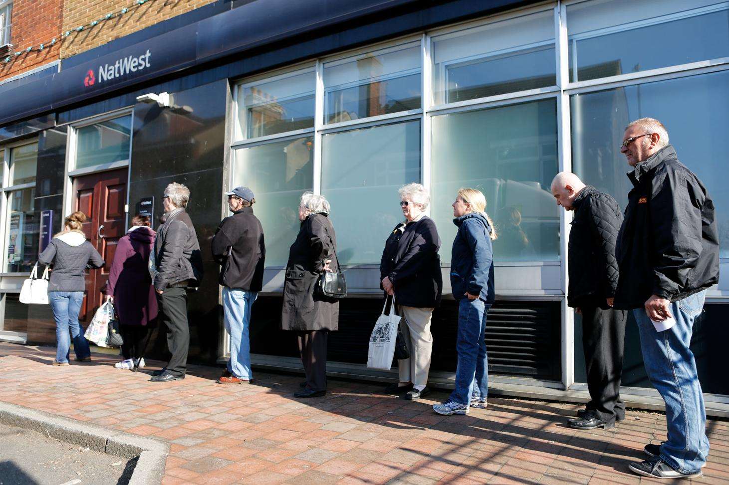 Queuing customers outside NatWest Bank in Snodland which will close in January