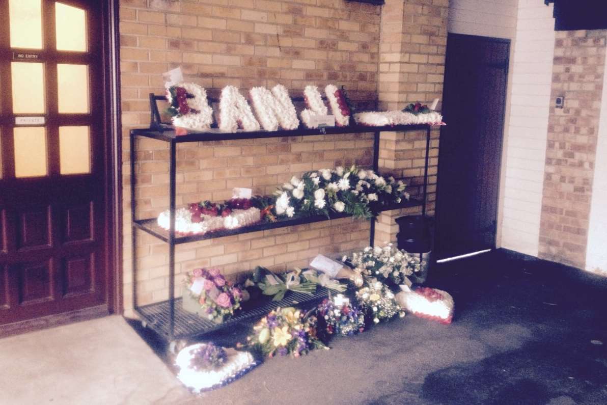 Floral tributes for Banji Ojikutu at his funeral.