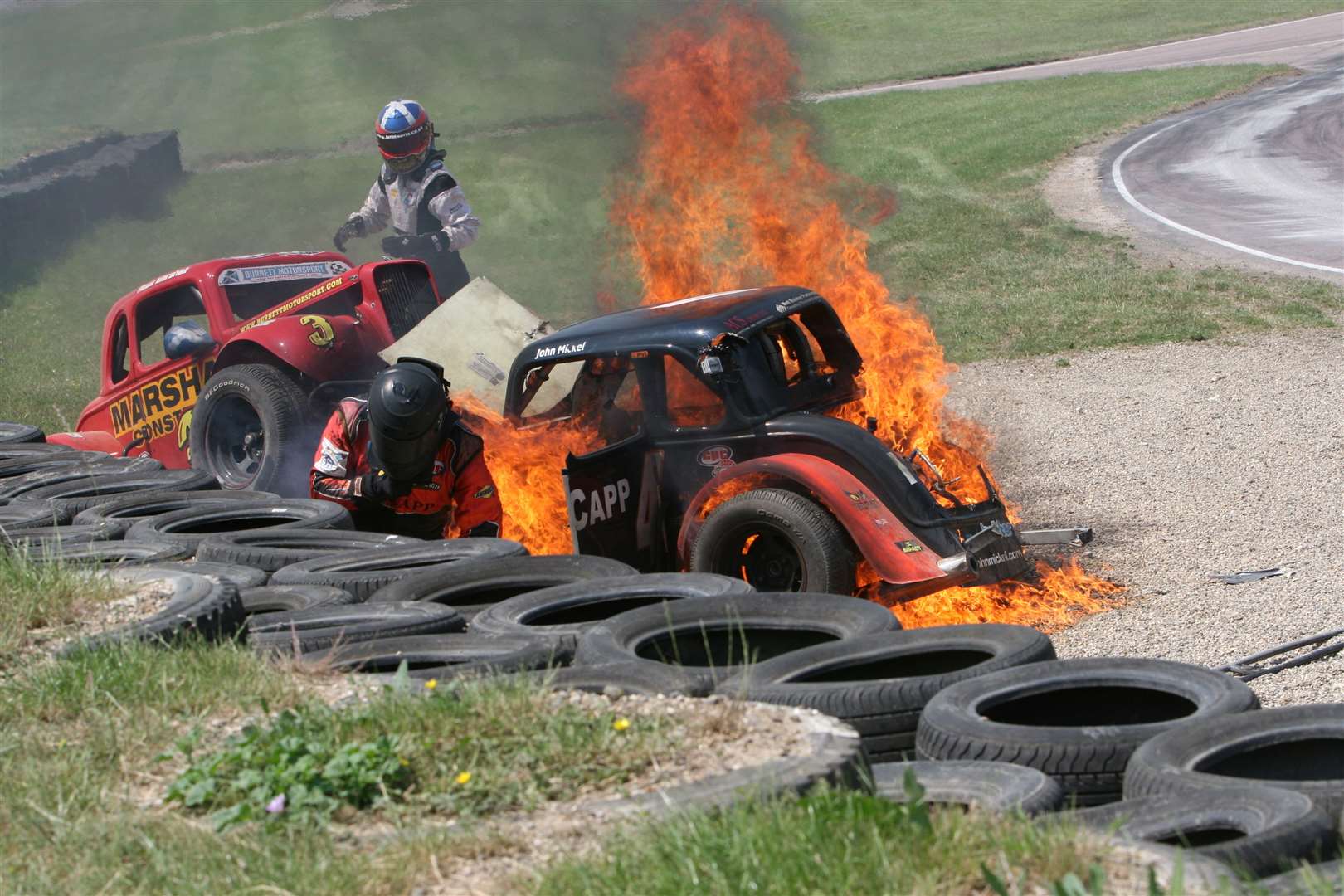Two Legends drivers - Ross Marshall and John Mickel - were lucky to escape from this fiery crash at Lydden Hill in June 2010. Picture: Kerry Dunlop