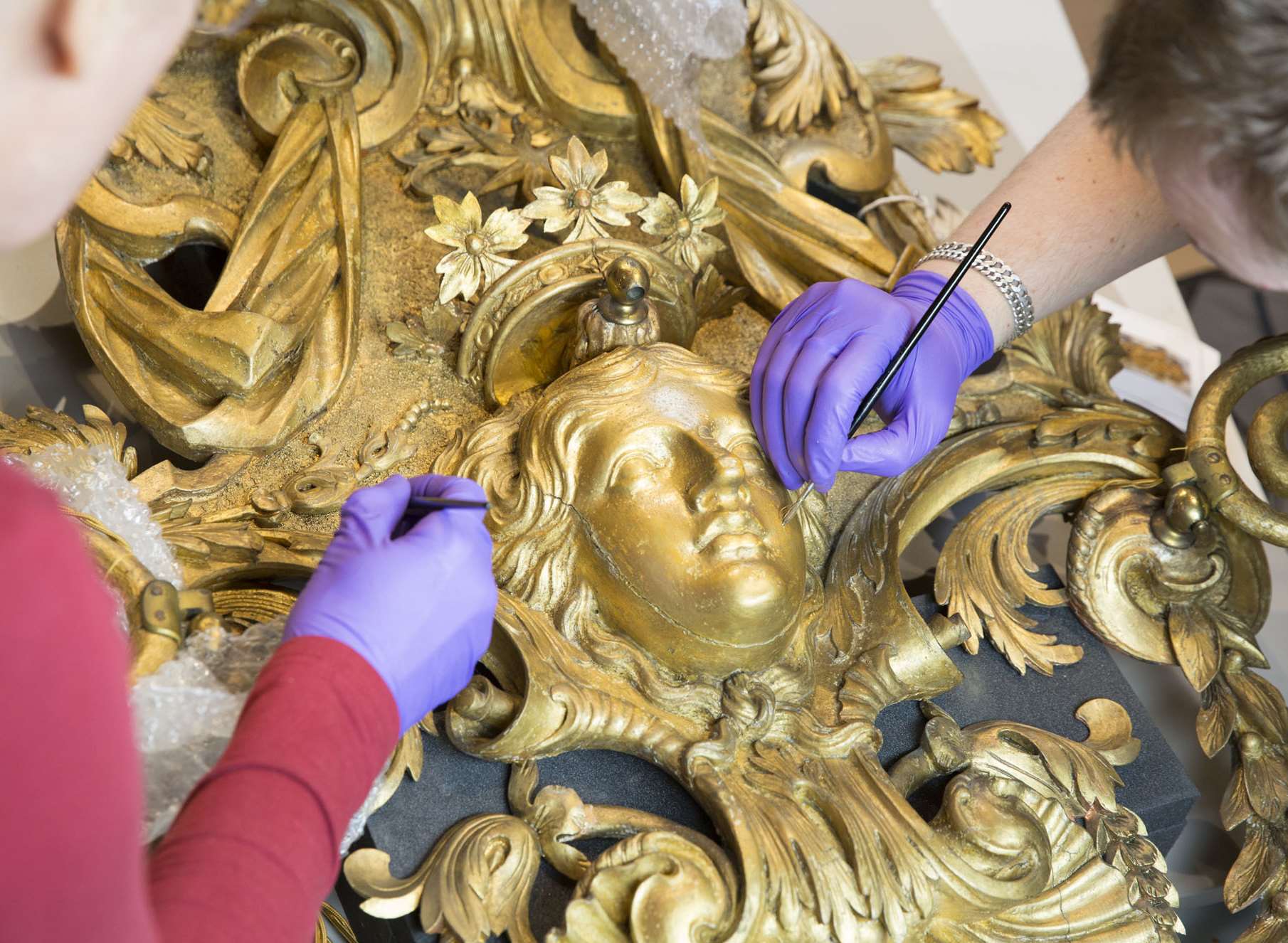 18th century William Kent designed, carved and gilded sconces from the Ballroom at Knole being restored. Picture: National Trust