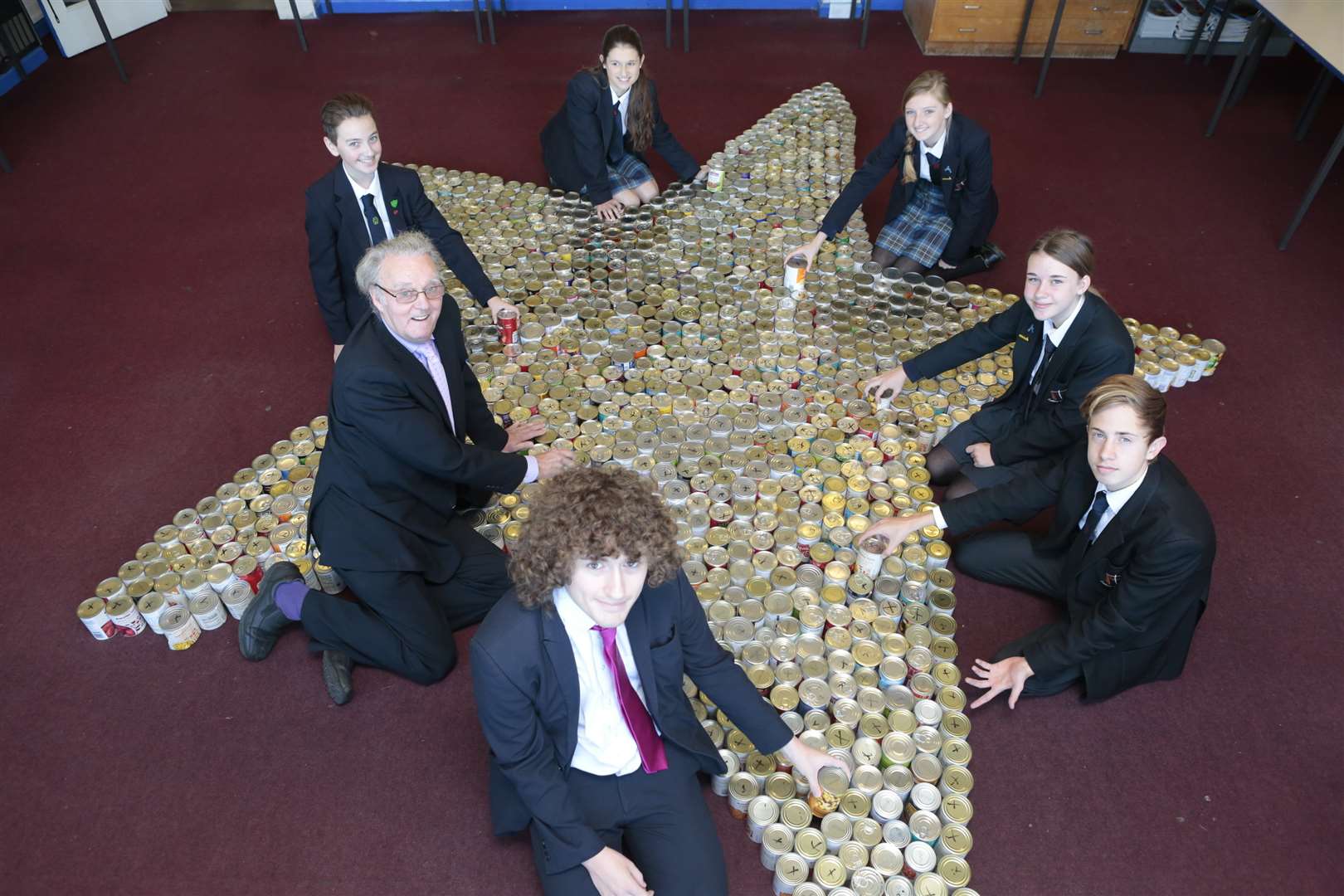 St Simon Stock students hand over 1,000 cans to the You Can Help appeal