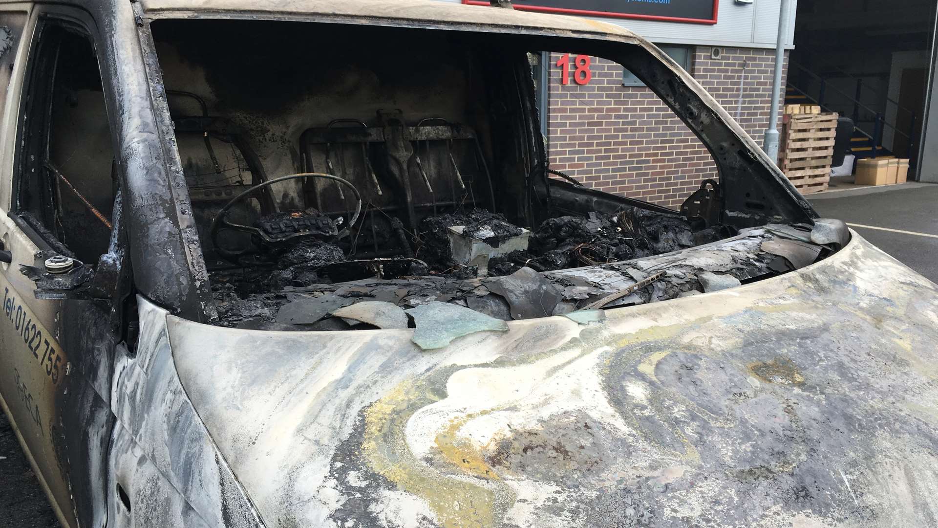A van parked outside Enhanced Controlled Services is badly damaged after the fire