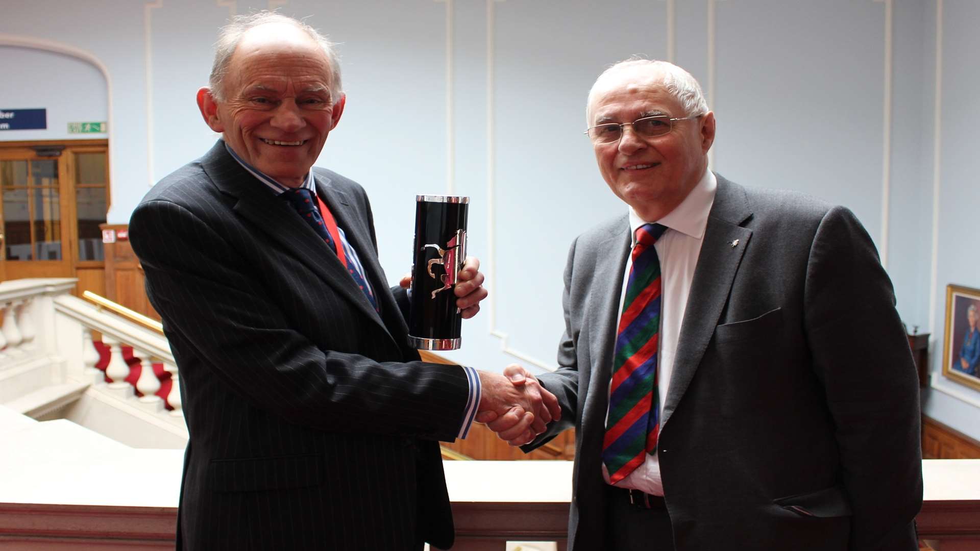 Maidstone Studios owner Geoff Miles, right, is presented with the Kent Invicta Award by KCC chairman David Brazier