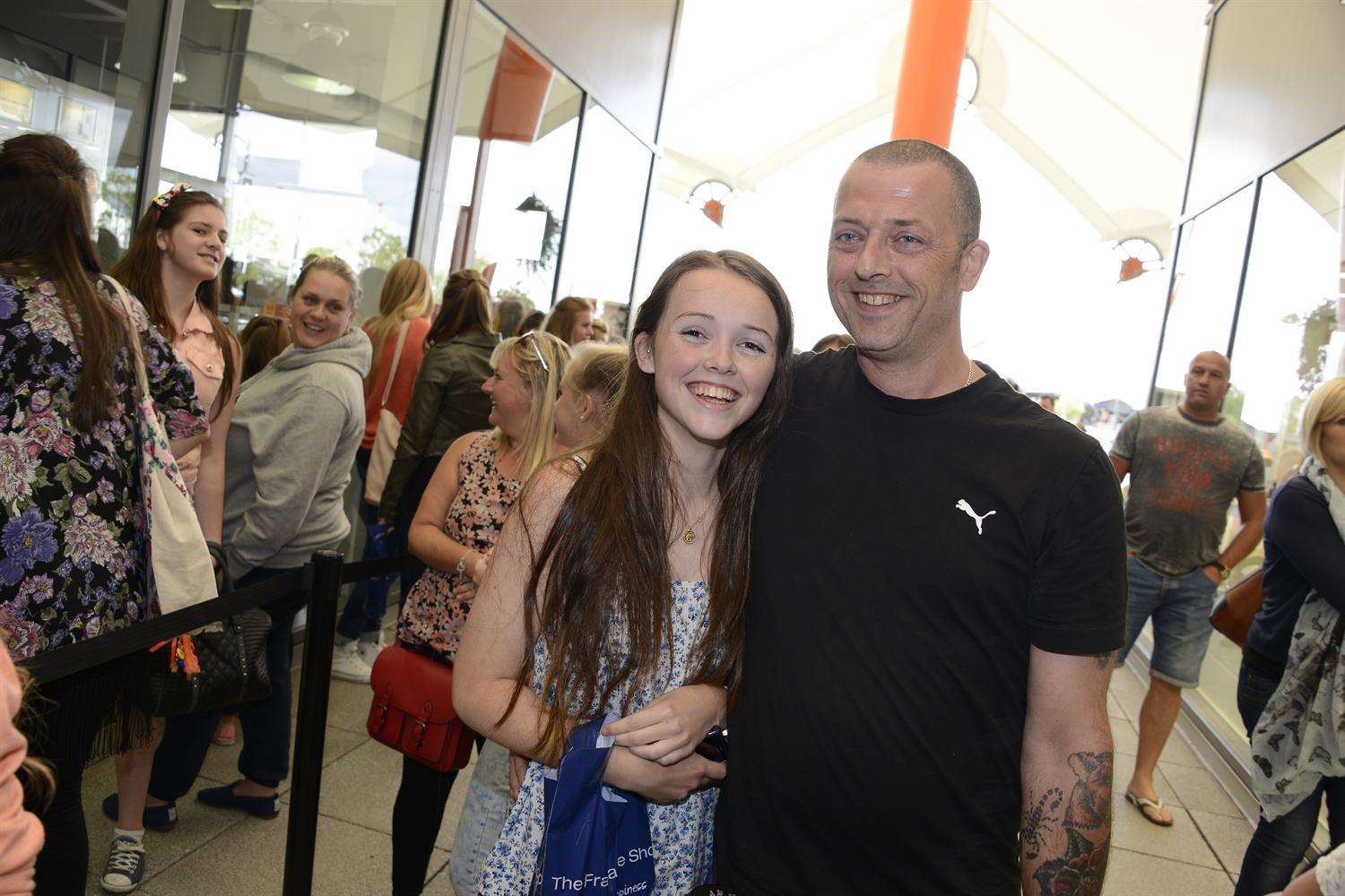 Dad Gary Blackford and daughter Yasmin in the queue outside The Fragrance Shop.