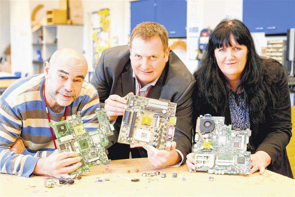 Tony Duke, Andrew Deeley and Lyn Baseley with the circuit boards and jewellery made from them