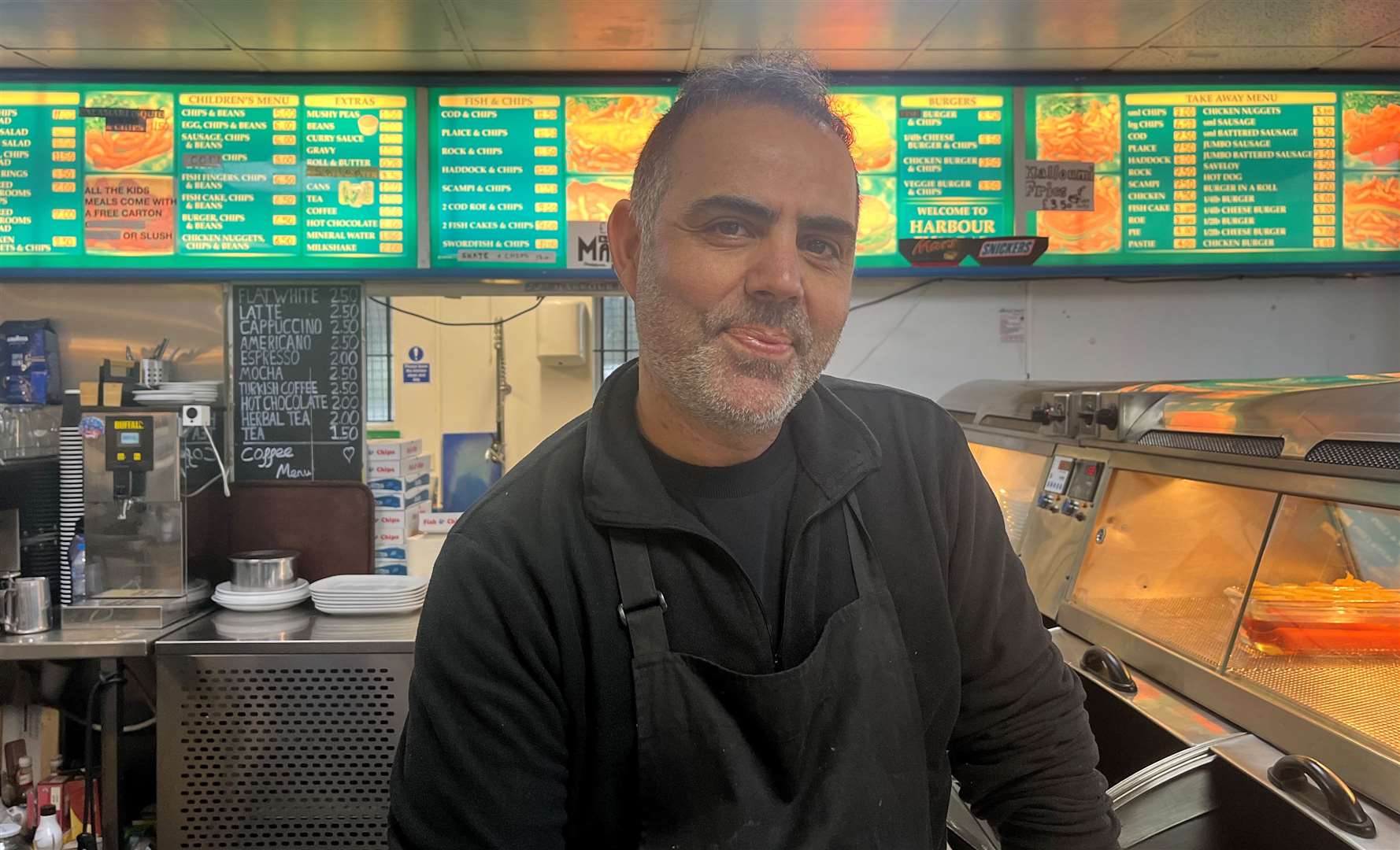 Harbour Fish Bar manager Murat Karakartal says his business will remain open despite the landslides behind the restaurant