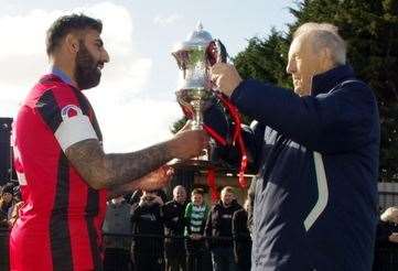 Erith Town captain Ryan Mahal is presented with the Challenge Cup by Southern Counties East president Ray Brown. Picture: John Anderson corkyboy@gmail.com