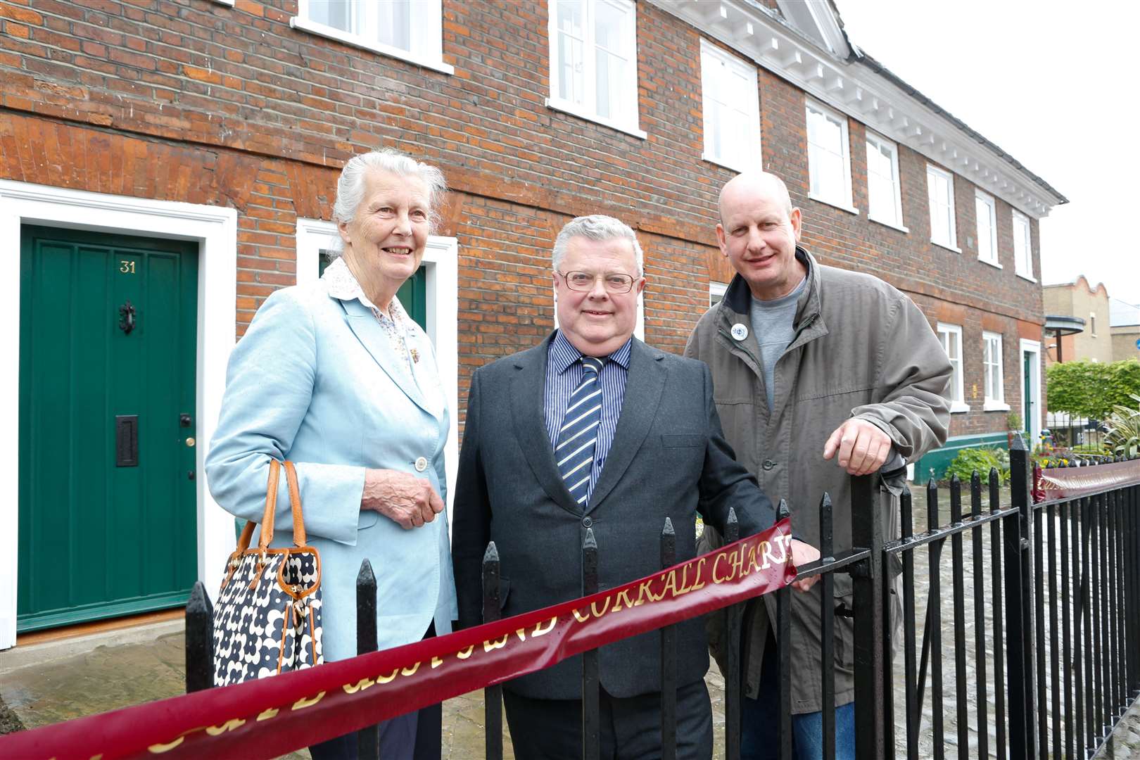 Paul Oldham, centre, pictured at the 2013 re-opening of the refurbished Sir John Banks Almshouses with fellow trustees Cllr Dave Naghi, right, and Jennifer Fenn