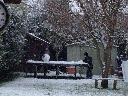 Rhys and Rowan Shardlow make snowballs in Ashford