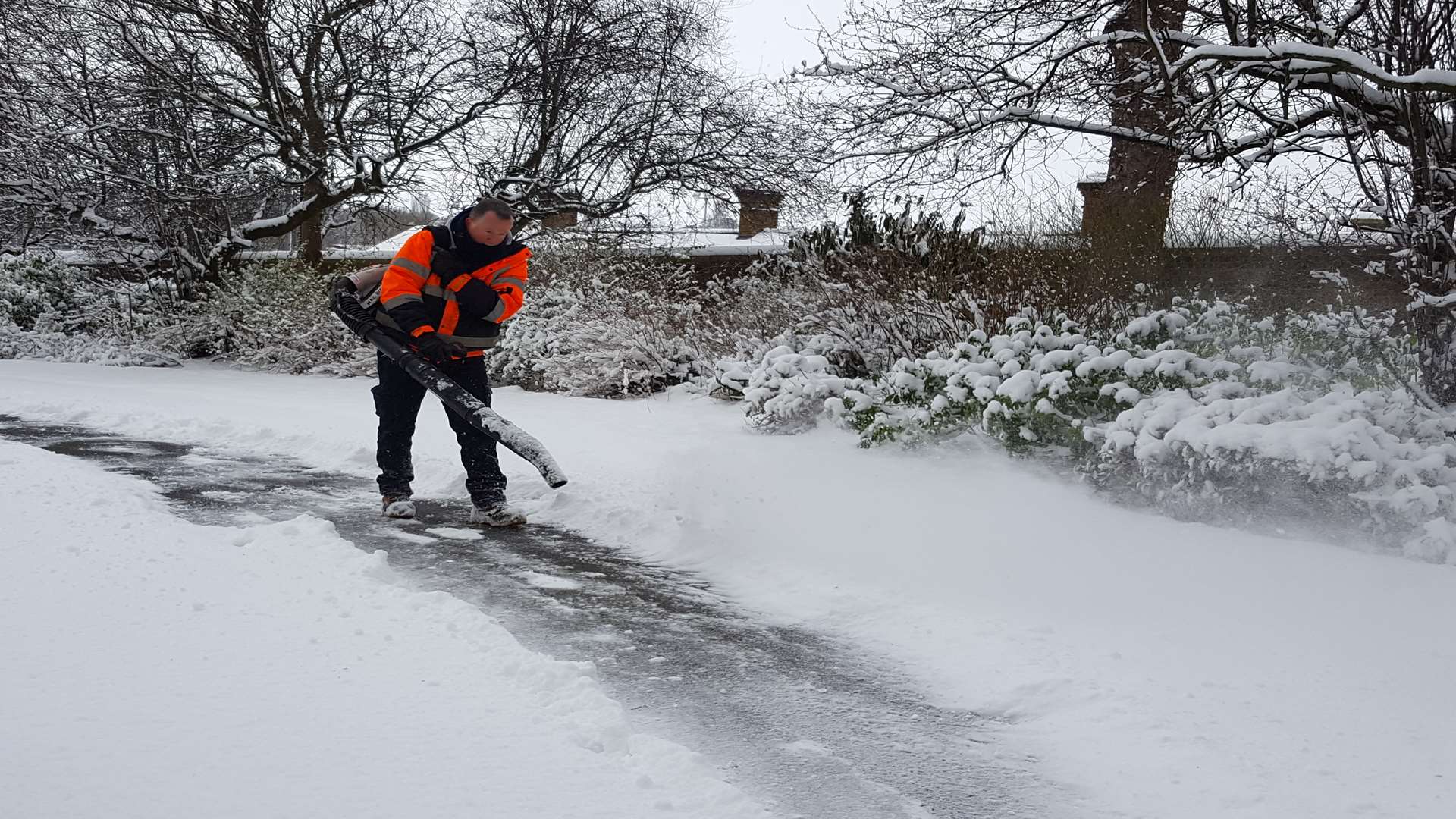 Council workers busily clearing the snow in Brenchley Gardens