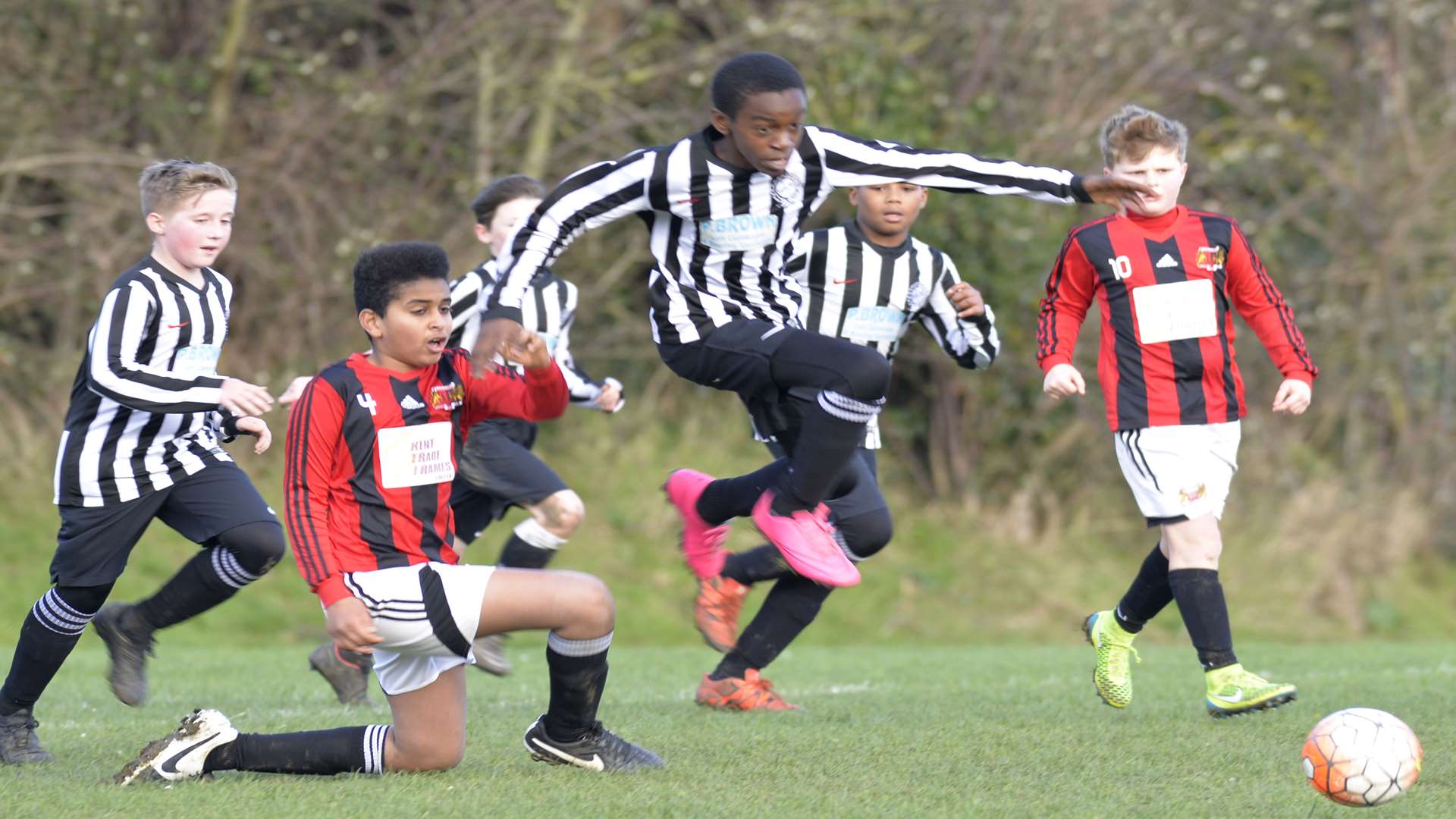 Real 60 Panthers (black and white stripes) get away from Woodcoombe Youth in the sides' Under-12 Division 2 clash Picture: Ruth Cuerden