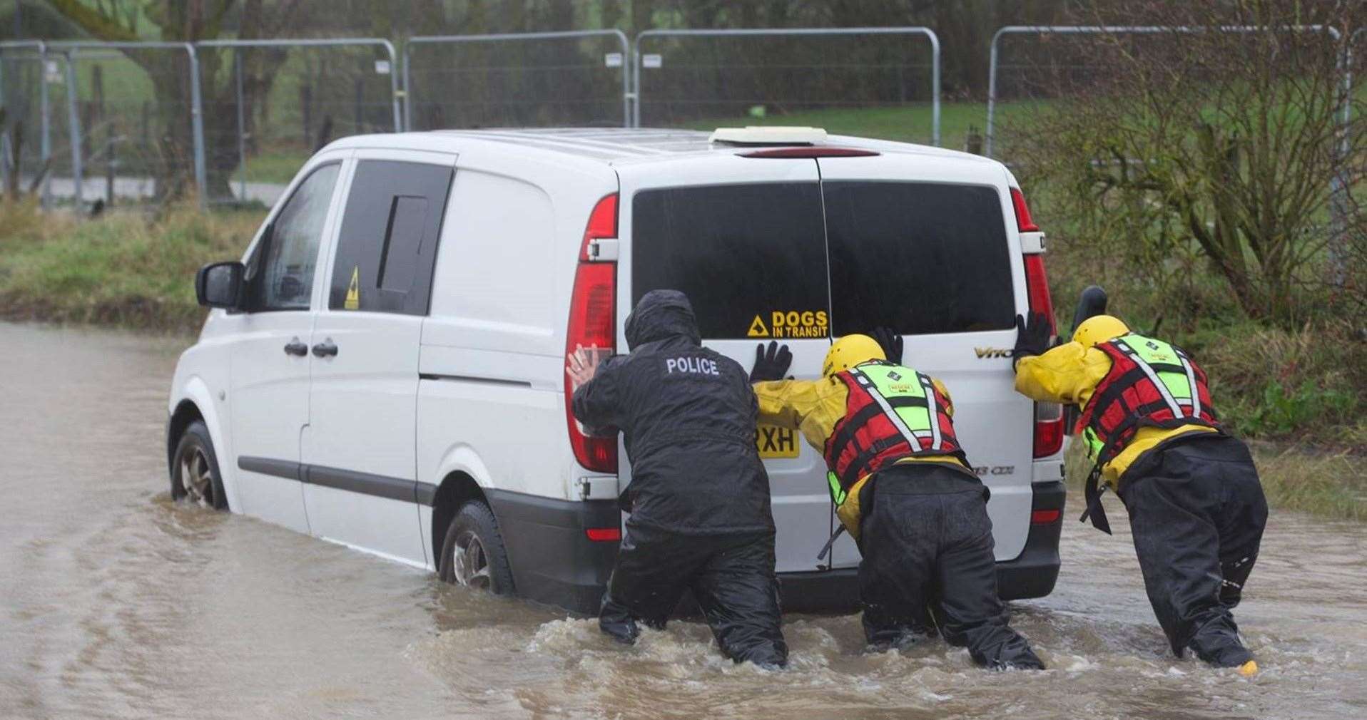 Two people and a dog were rescued after a van became stuck in flood water. Picture: KFRS
