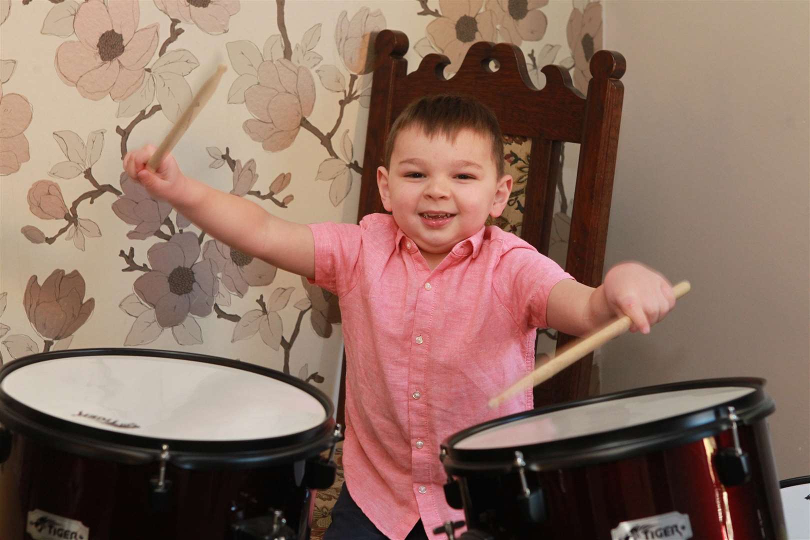 Tony Hudgell, four, playing drums. Picture: John Westhrop