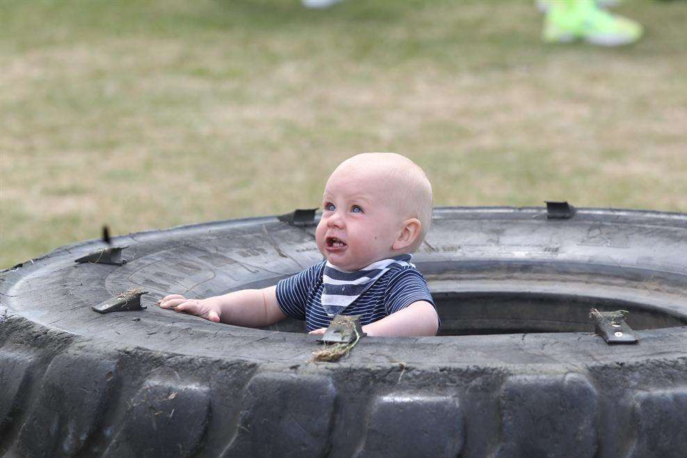 Jameson Neil, one years old stands in a tyre at a strongman competition. His father took part in the competition at Gravesend Town Regatta and Fusion Festival.