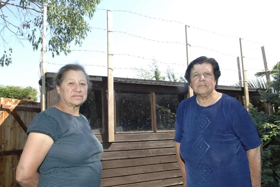 Scared Sheena and Eve Ahmet have set up barbed wire fencing around their shed after they saw intruders jumping on it