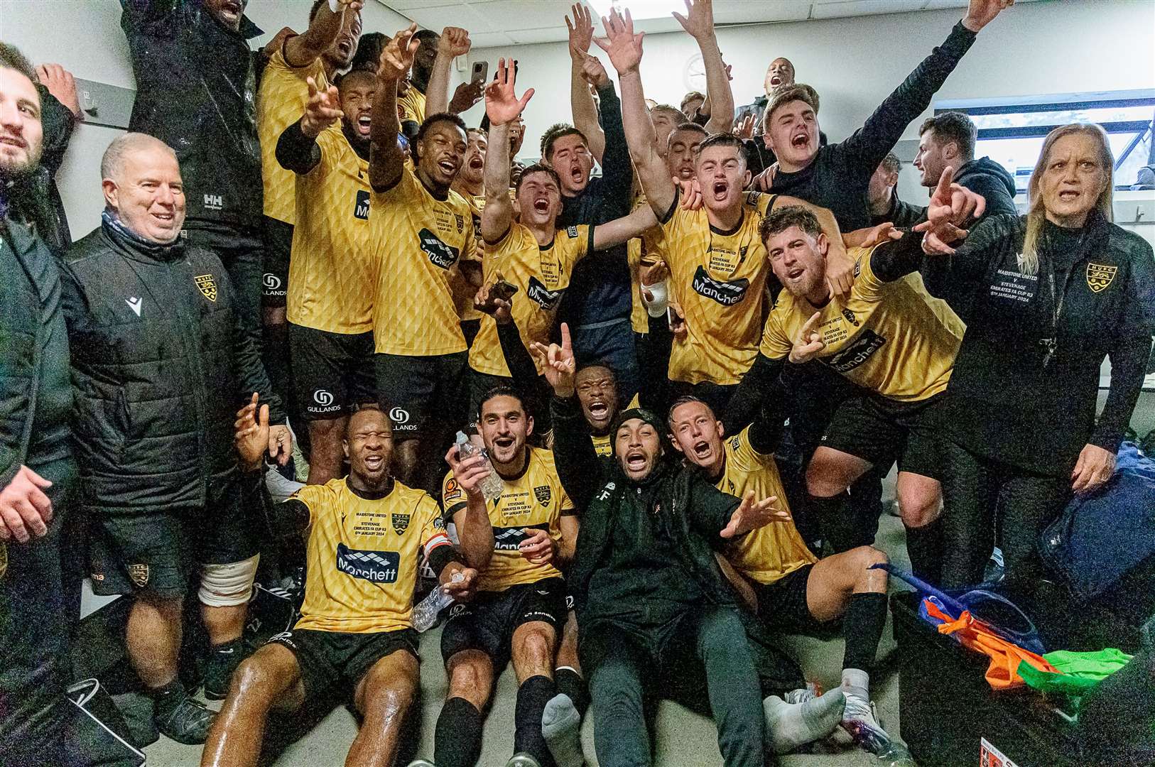 Jamie Hemsley, back row, right, joins the celebrations after Maidstone's FA Cup third-round win over Stevenage. Picture: Helen Cooper