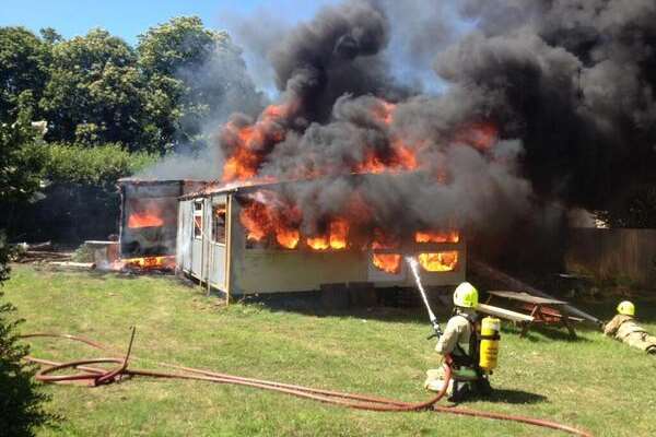 Firefighters tackle the blaze at portable buildings. Picture: Kent Fire and Rescue