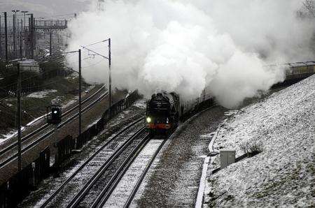 Tornado, an A1 class steam engine speeds past a quiet high speed line near the Channel Tunnel
