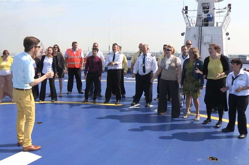 The choir rehearse on the top deck of a ferry.
