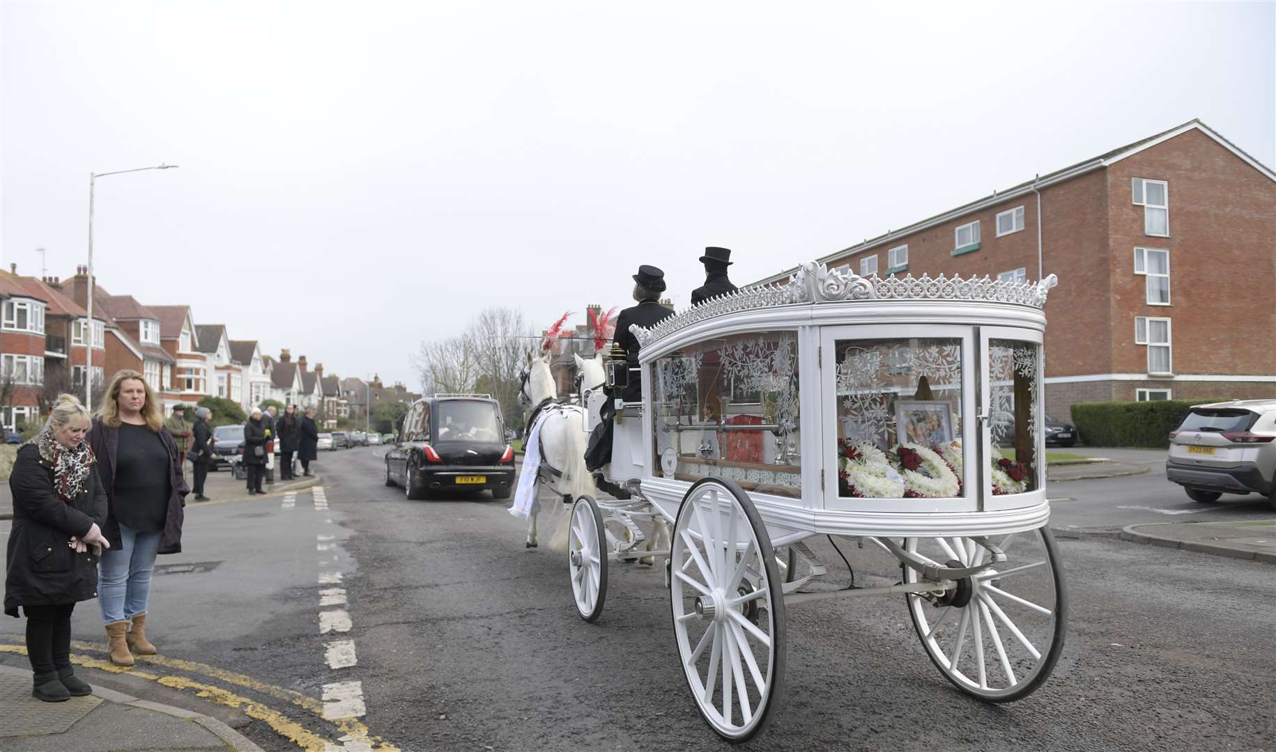 William Brown Jrs coffin is carried to The Church of St Mary and St Eanswythe, Folkestone, by a horse and carriage bearing the colours of his beloved Manchester United. Picture: Barry Goodwin