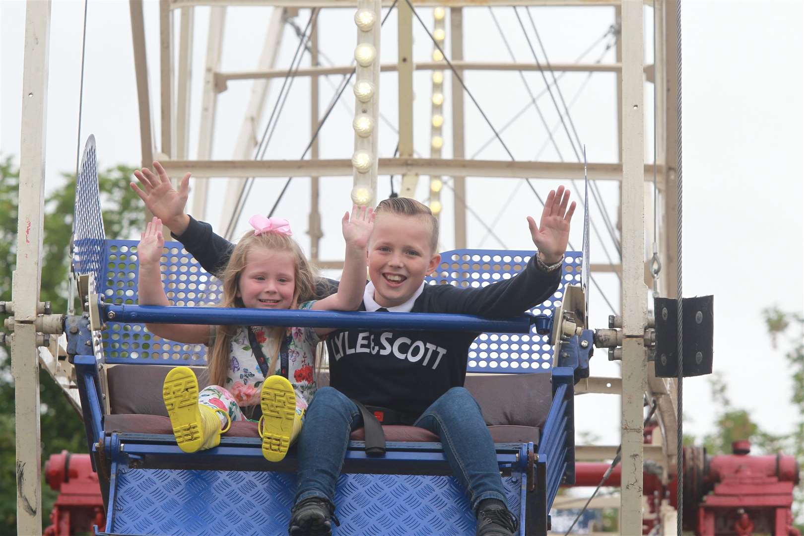 From left, Grace Brooker, four with her brother, Lee, 12 on a big wheel at the Kent County Show. Picture: John Westhrop. (13505729)