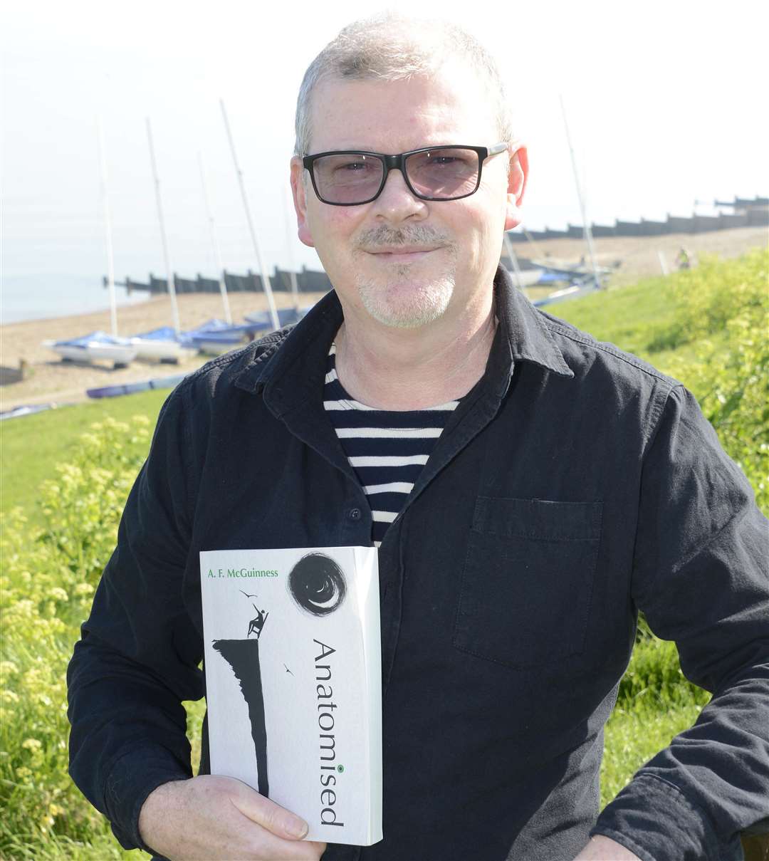 Whitstable Tankerton Slopes.Author Andrew McGuinness with his new book.Picture: Paul Amos. (3342376)