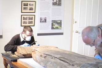 Experts work on the Egyptian coffin lid