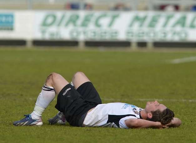 A dejected Lee Noble lies on the turf at full-time Picture: Andy Payton