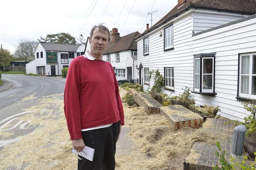 Mark Oliver outside his house at the aftermath of accident involving a shed load of straw