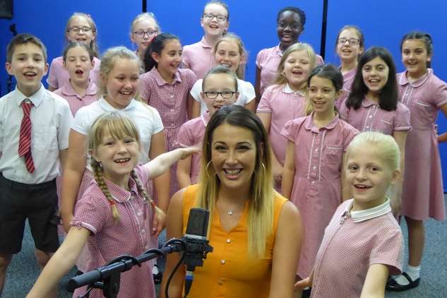 Contest judge Leah Macdonald of 3R's Teacher Recruitment with Walderslade Primary School choir, winners of the 2017 Song Contest.