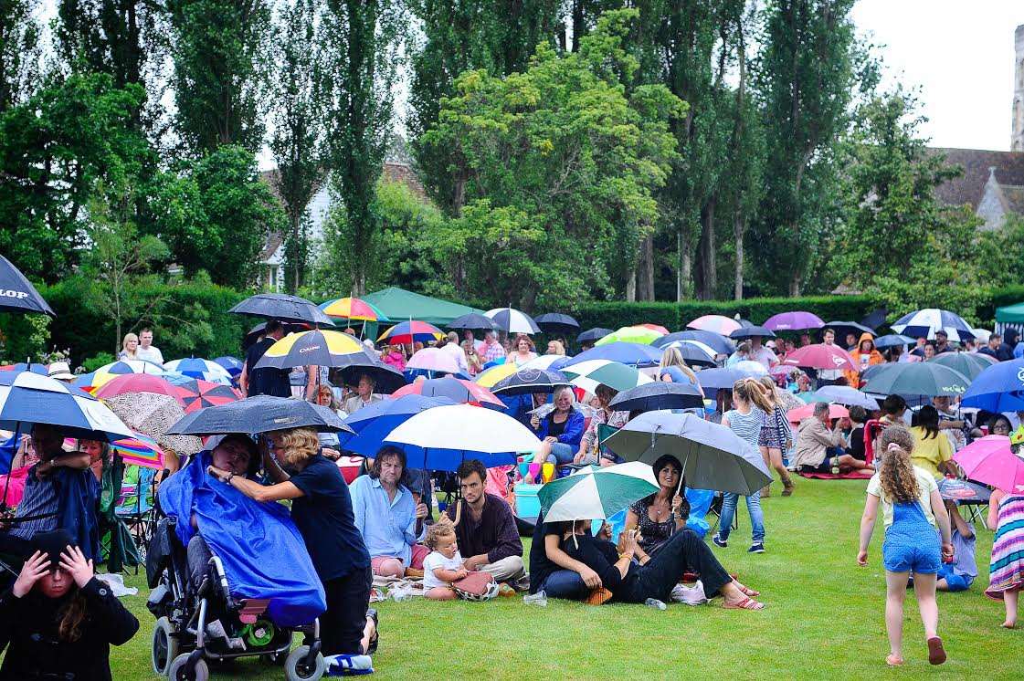 Umbrellas at the ready: The rain did not deter people from attending the event last Sunday.