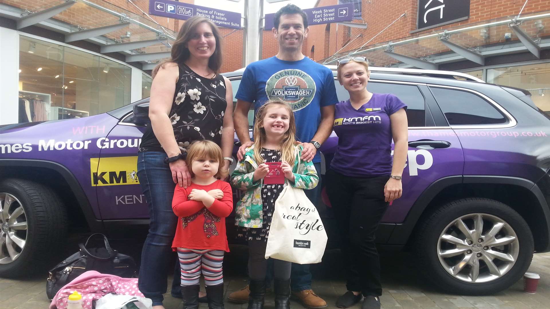 Left to right: Mother Becky Carlisle with father Chris Carlisle and kmfm's Katie Foster. In front are two-year-old Ellie Carlisle and competition winner Amy, aged 5
