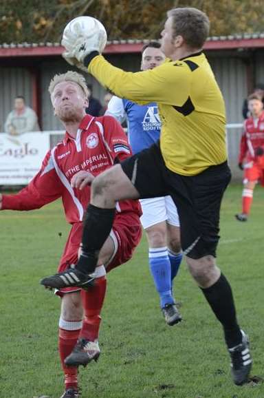 Josh Burchell battles for the ball against Burgess Hill.