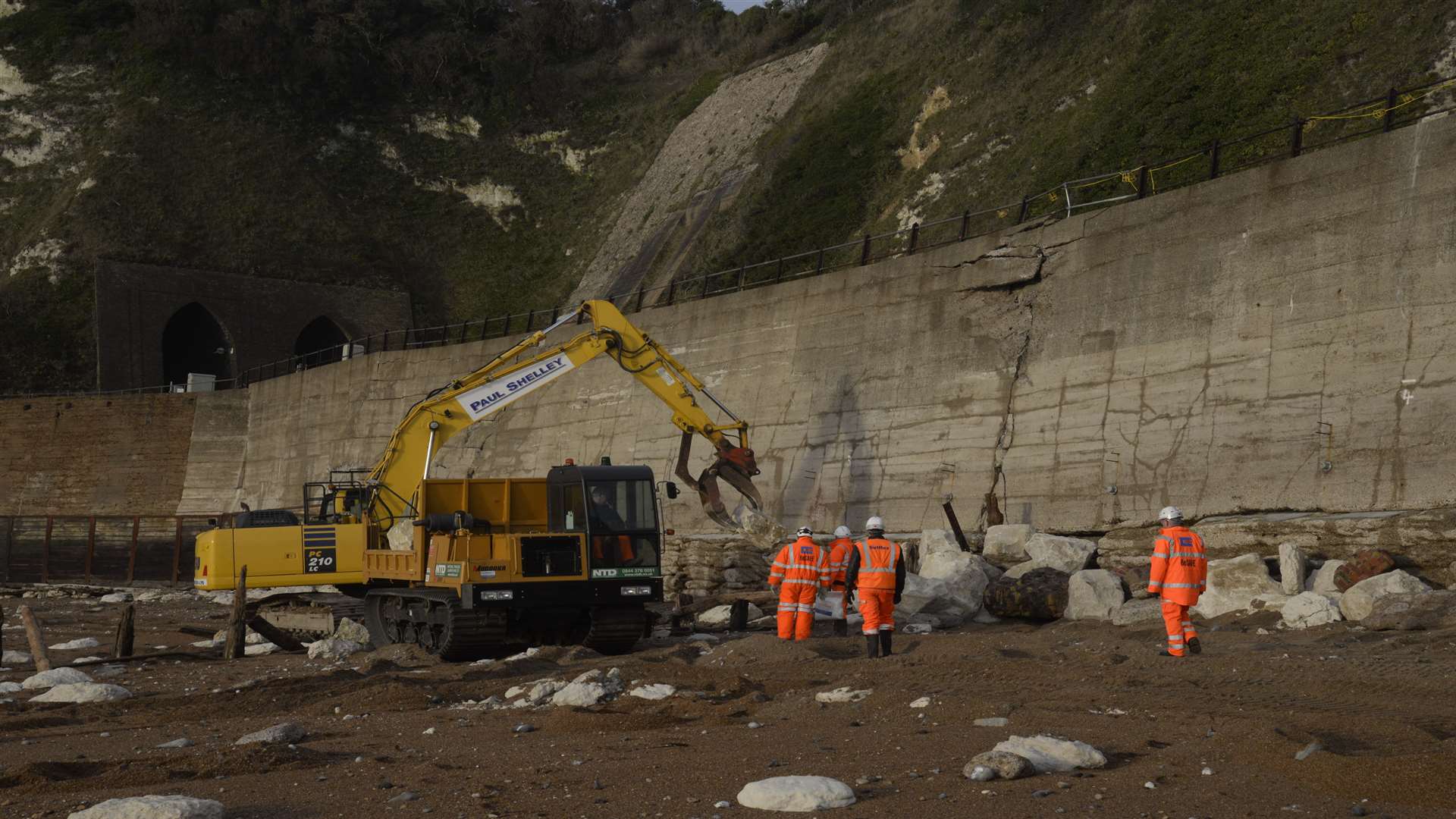 The damaged sea wall and railway embankment near Shakespeare Cliff tunnel between Dover and Folkestone