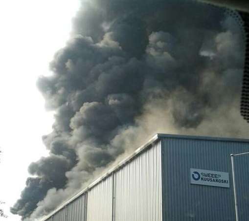 Skies around the recycling depot were turned black by smoke. Picture: Richard Tolley