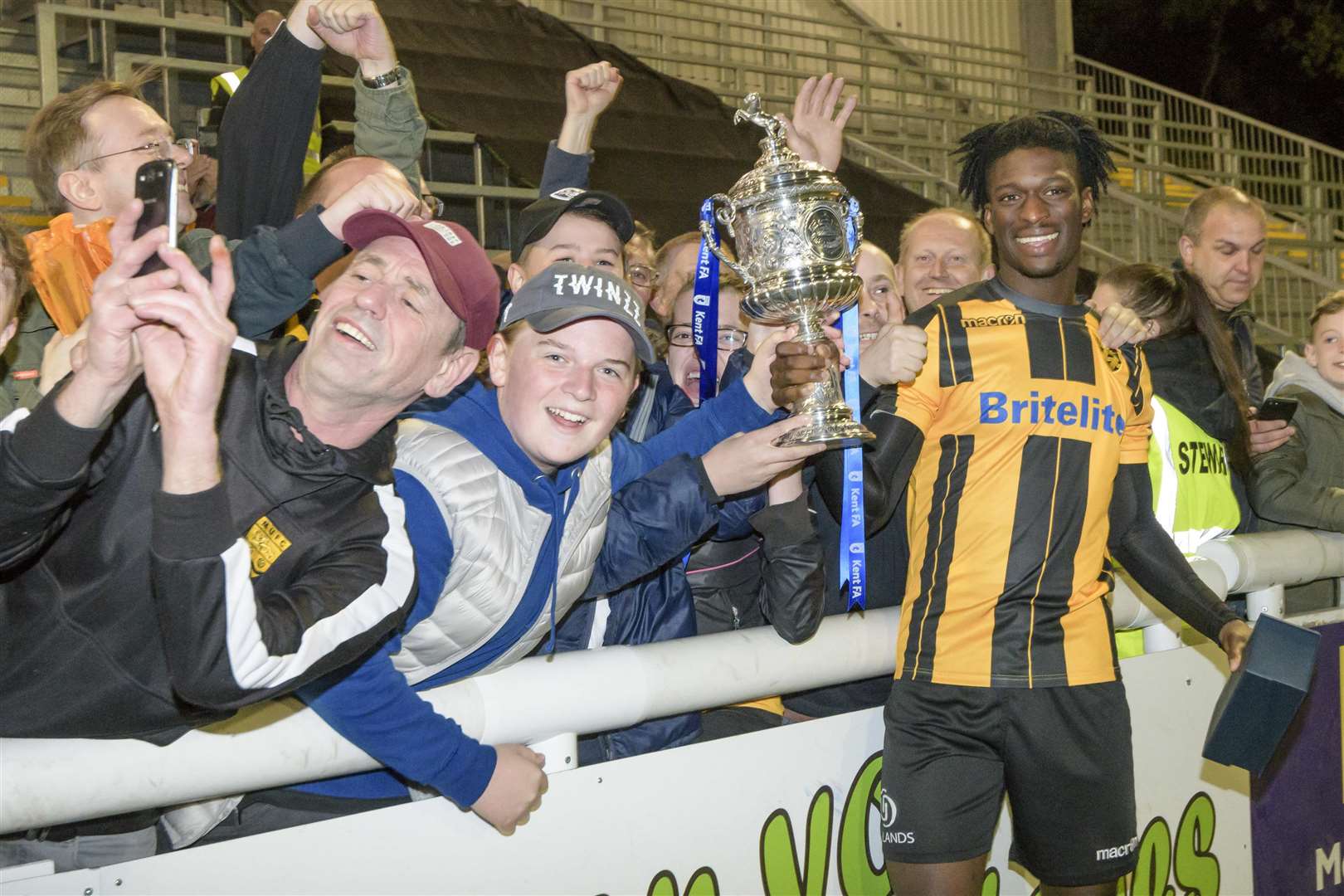 Andre Coker with fans and the Kent Senior Cup Picture: Andy Payton