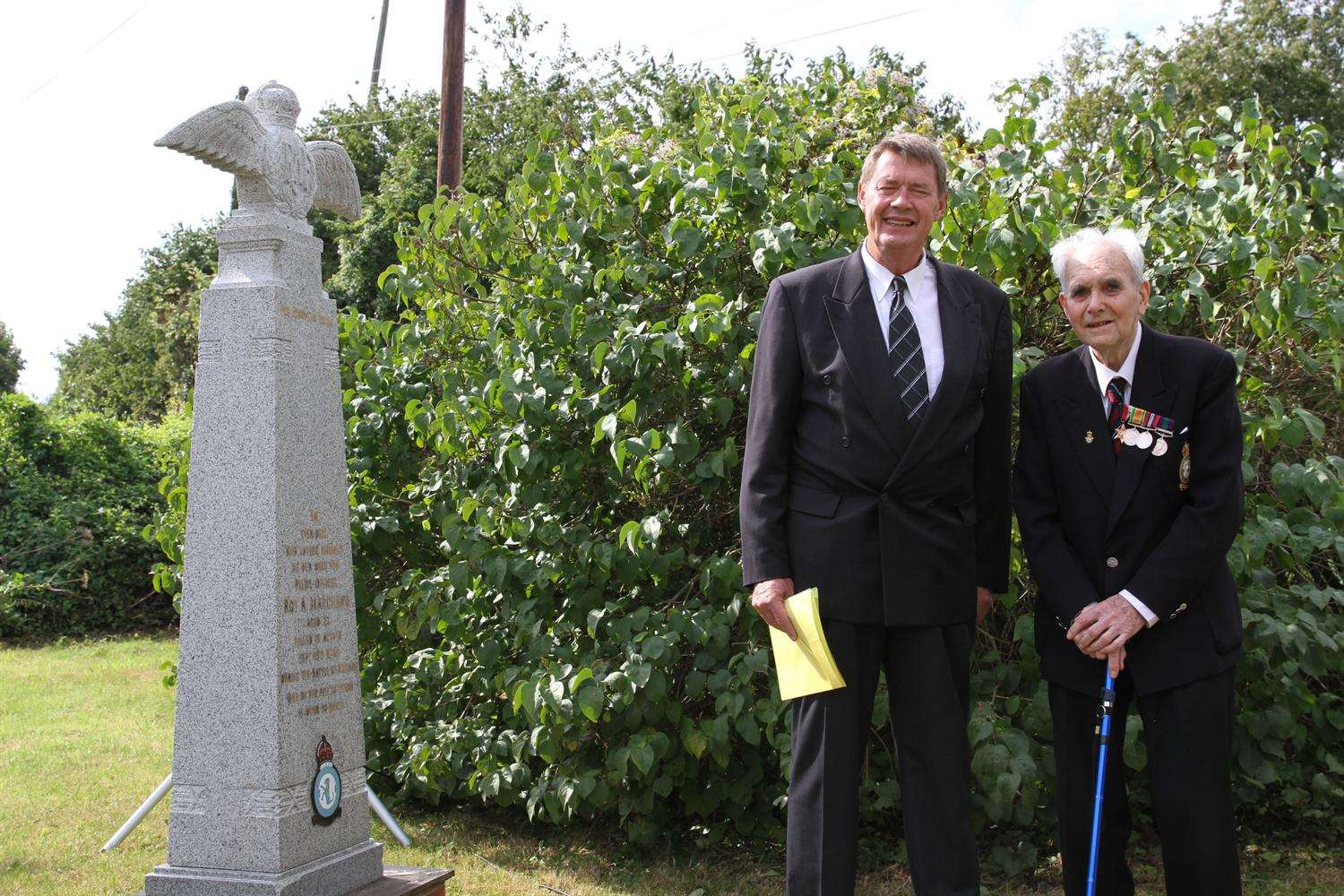 Rene Marchand (left) nephew of Roy Marchand, and ex-Squadron Leader Leslie Armstrong stand next to the memorial at Nouds Farm.