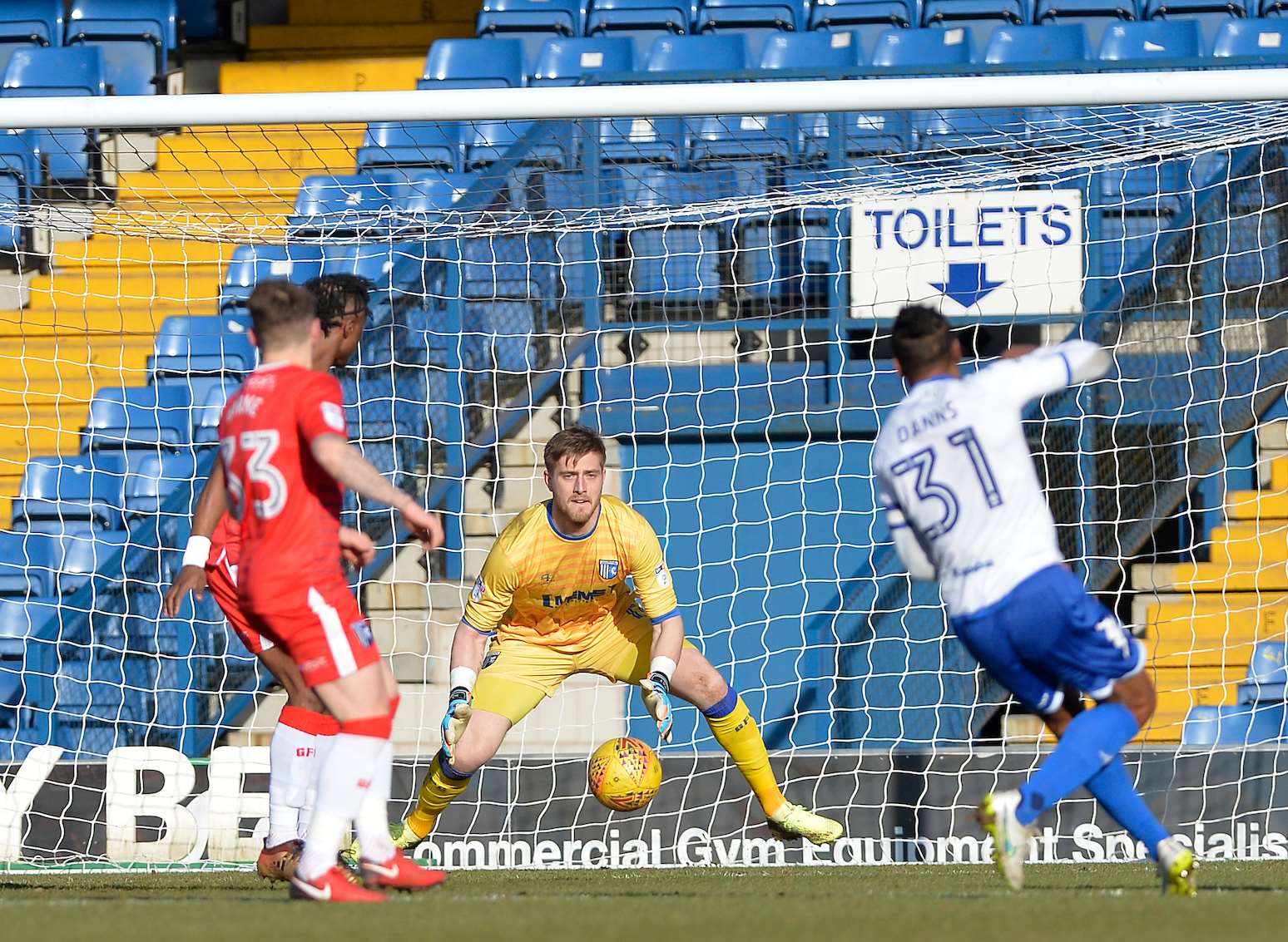 Neil Danns opens the scoring for Bury, beating Tomas Holy from outside the box Picture: Ady Kerry
