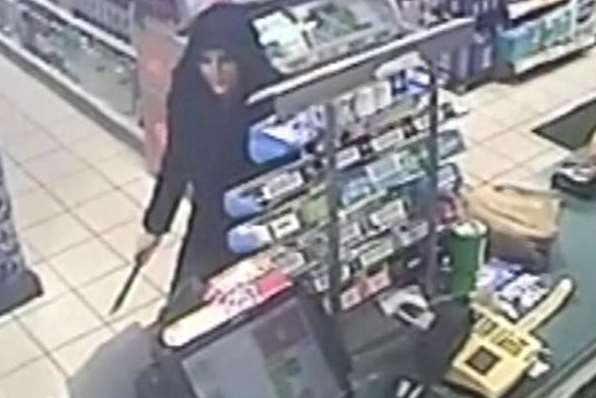 Hooded robber Anna Chambers wields a knife at Murco in South Ashford