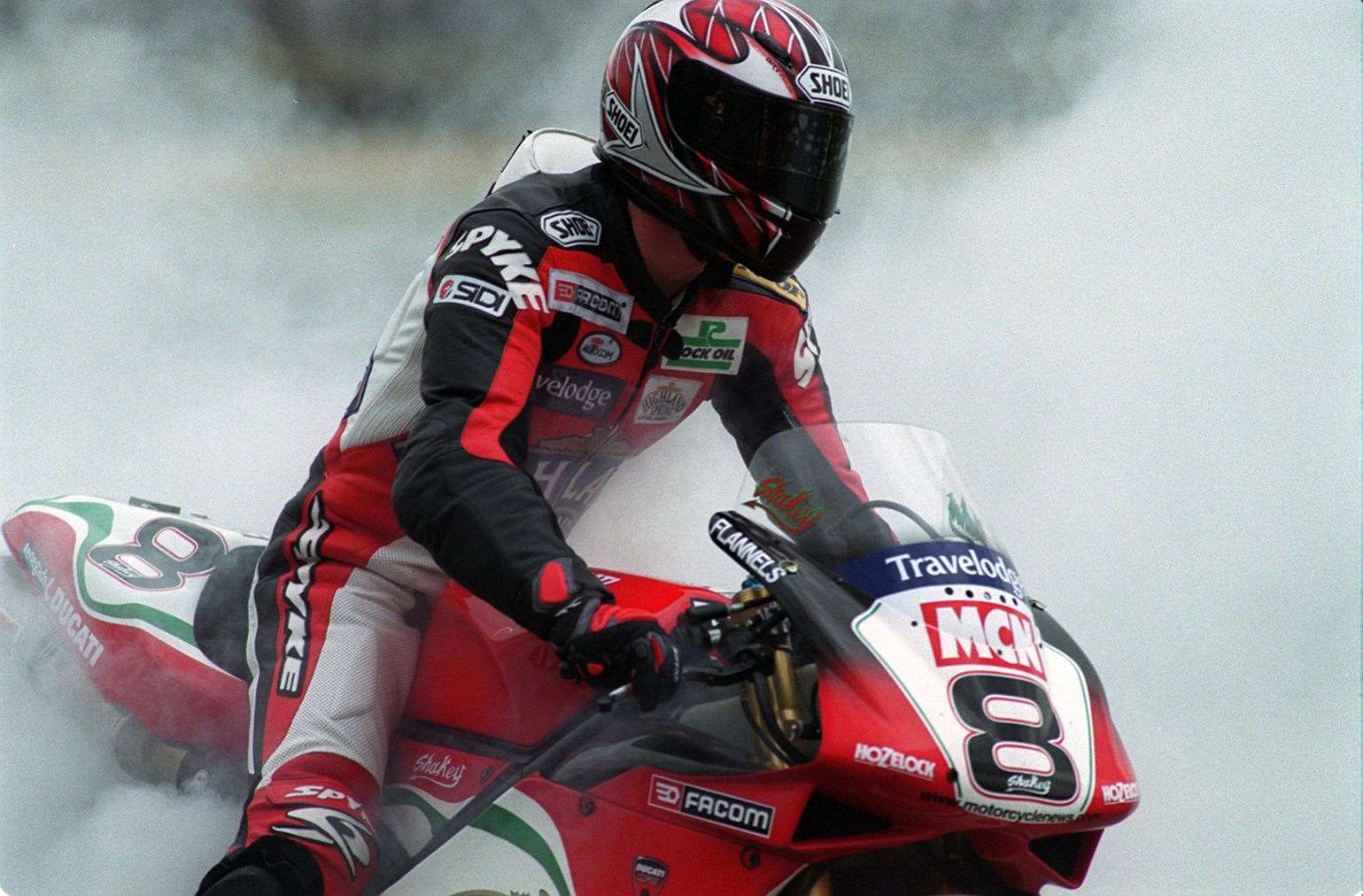 Surrounded by tyre smoke, Shane 'Shakey' Byrne performs a doughnut in front of his home fans in 2002. Picture: Andy Payton