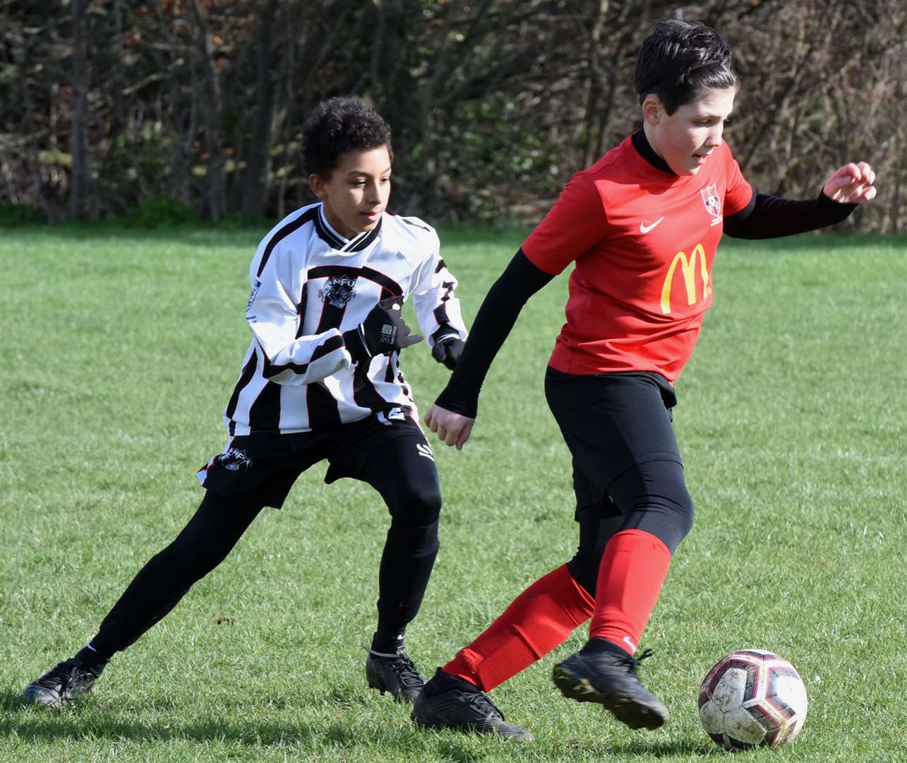 Thamesview under-12s (red) are closed down by Milton & Fulston United under-12s. Picture: Ken Mears FM30535435
