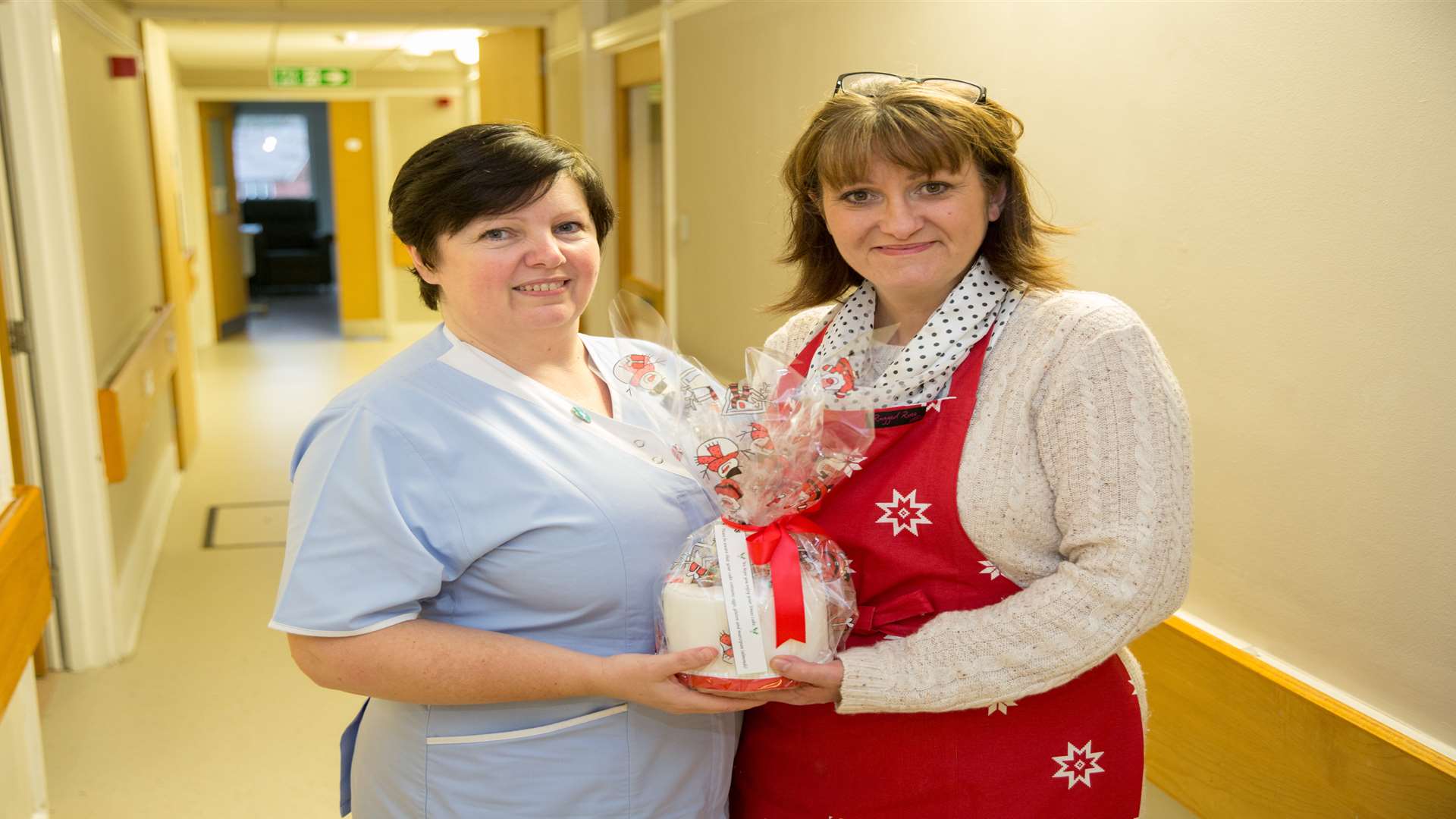 Debbie Wells presents Hospice Nurse Karen Goddard with a cake from her company Bonne Bouche