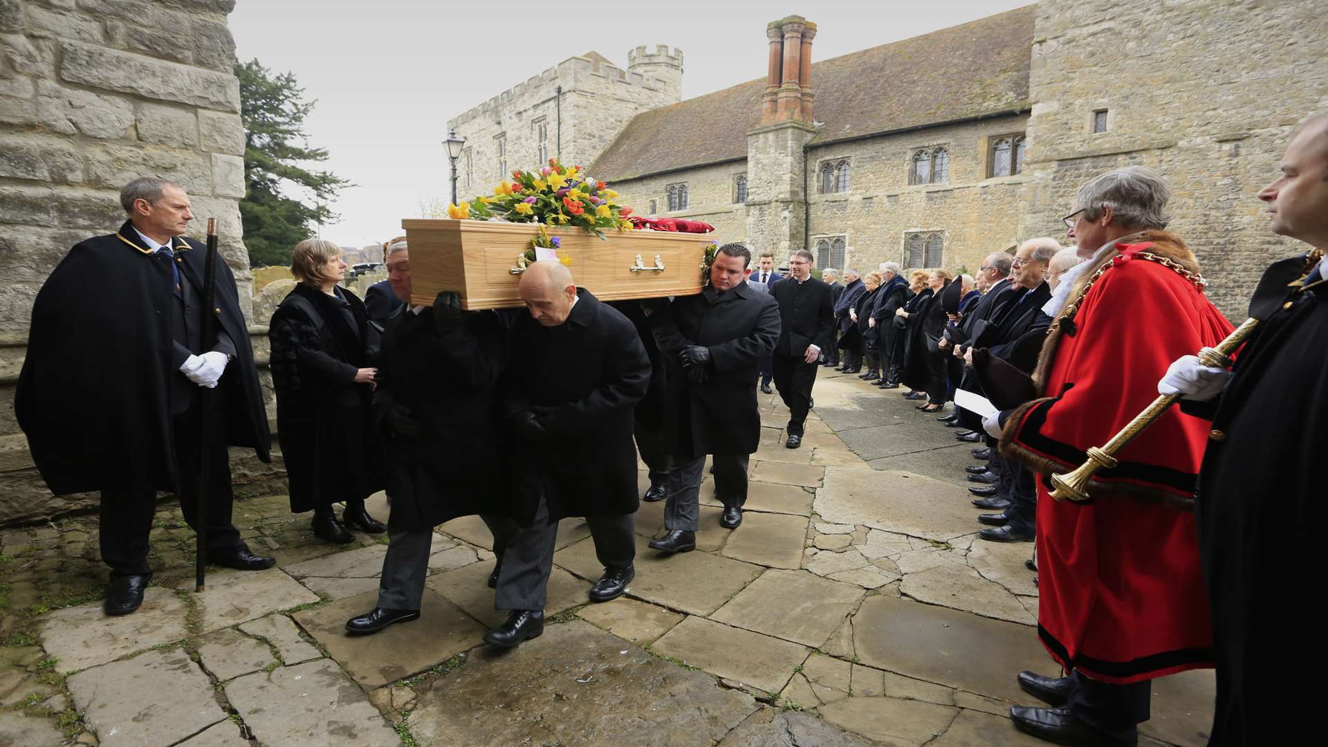 Mourners line the path of All Saints Church, Maidstone, for the funeral of Peter Parvin.
