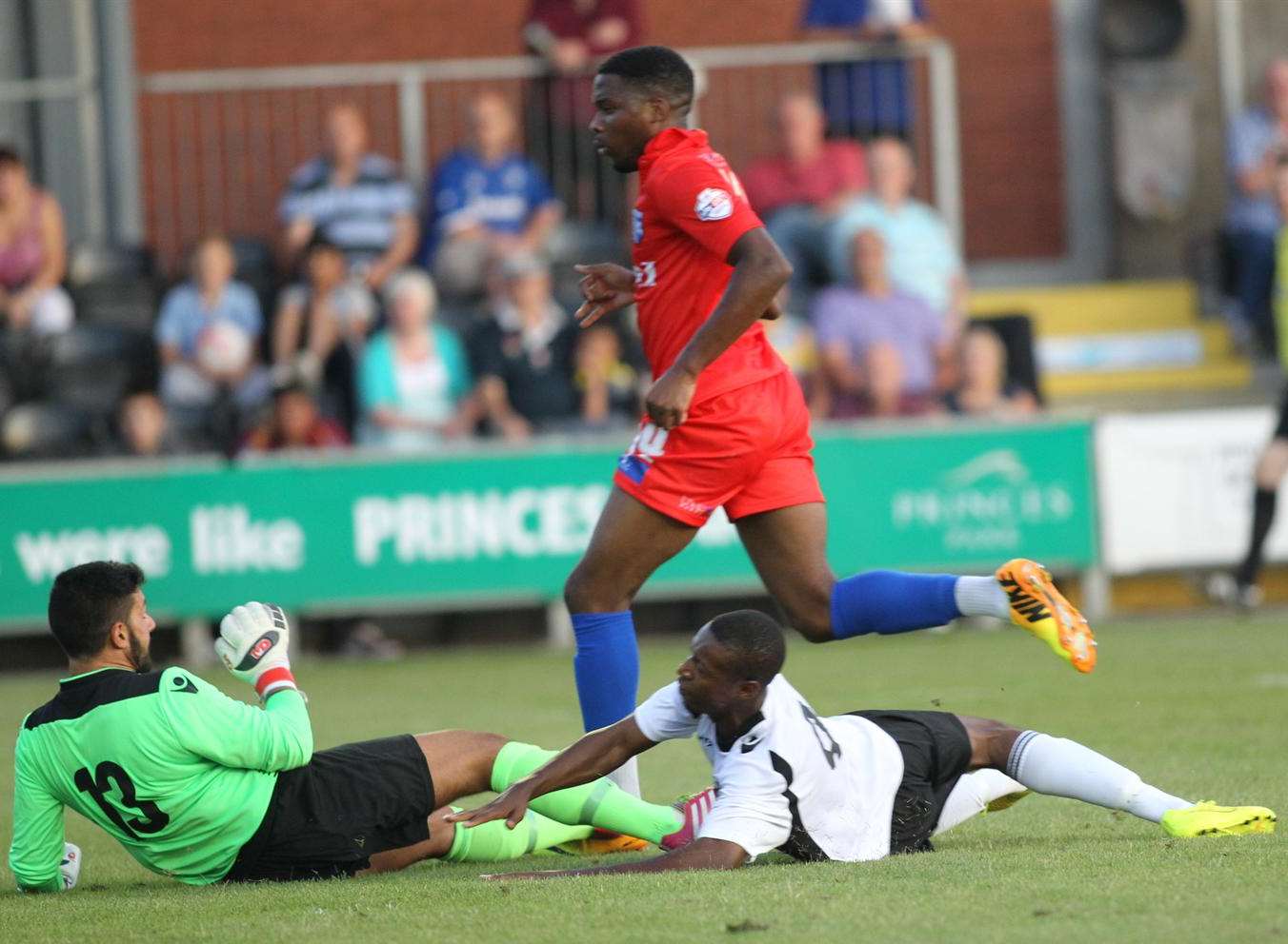 Gillingham's Antonio German leaves Dartford pair Deren Ibrahim and Nathan Collier on the floor Picture: John Westhrop