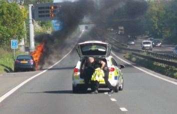 Police holding back traffic on the M2 after a car caught fire. Picture: Francis J Santos